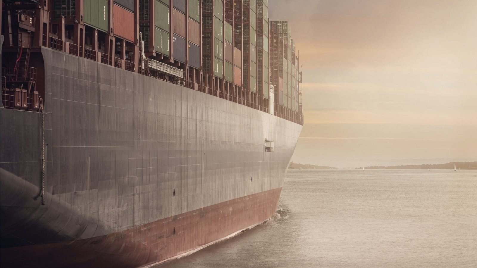 A loaded container ship at dusk