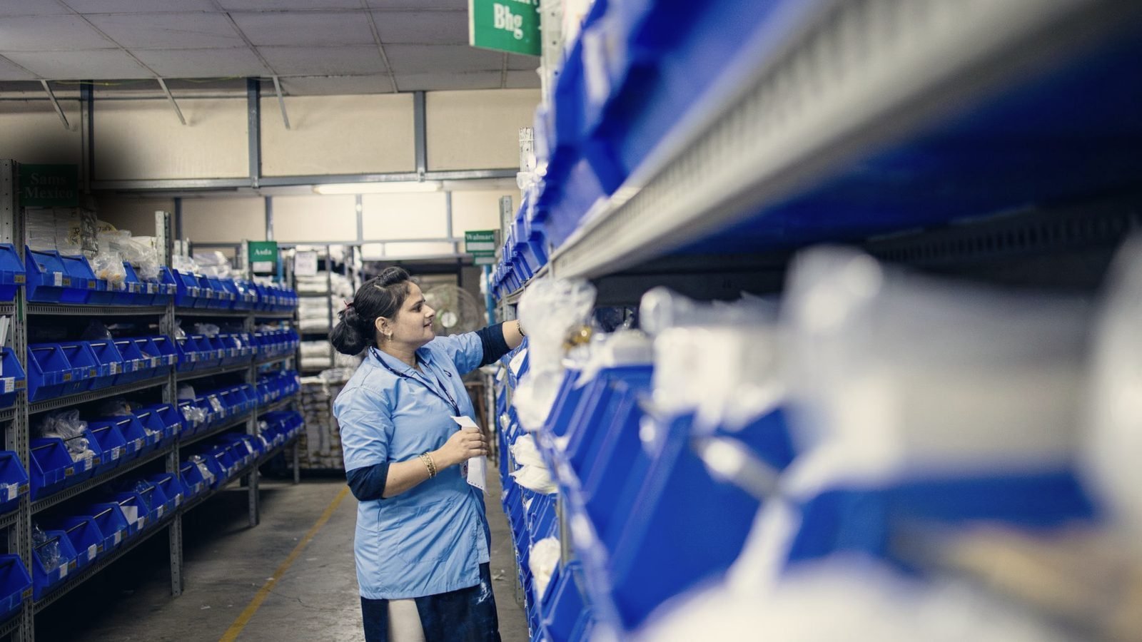 Parts warehouse aisle with stocked picking bins